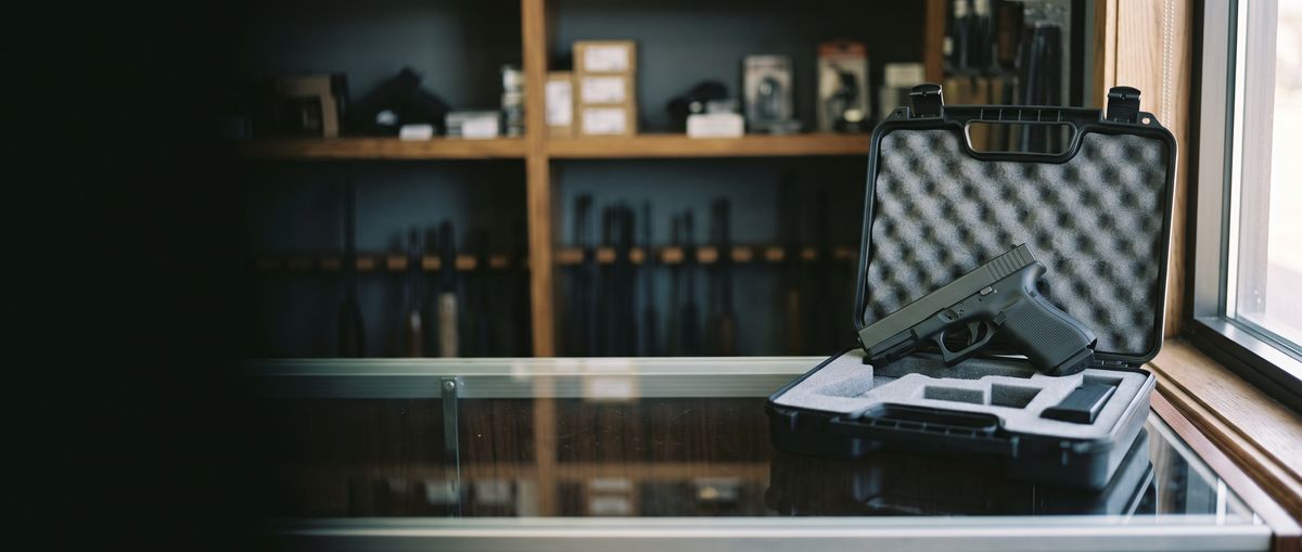 Handgun in an open hard case on a gun shop counter